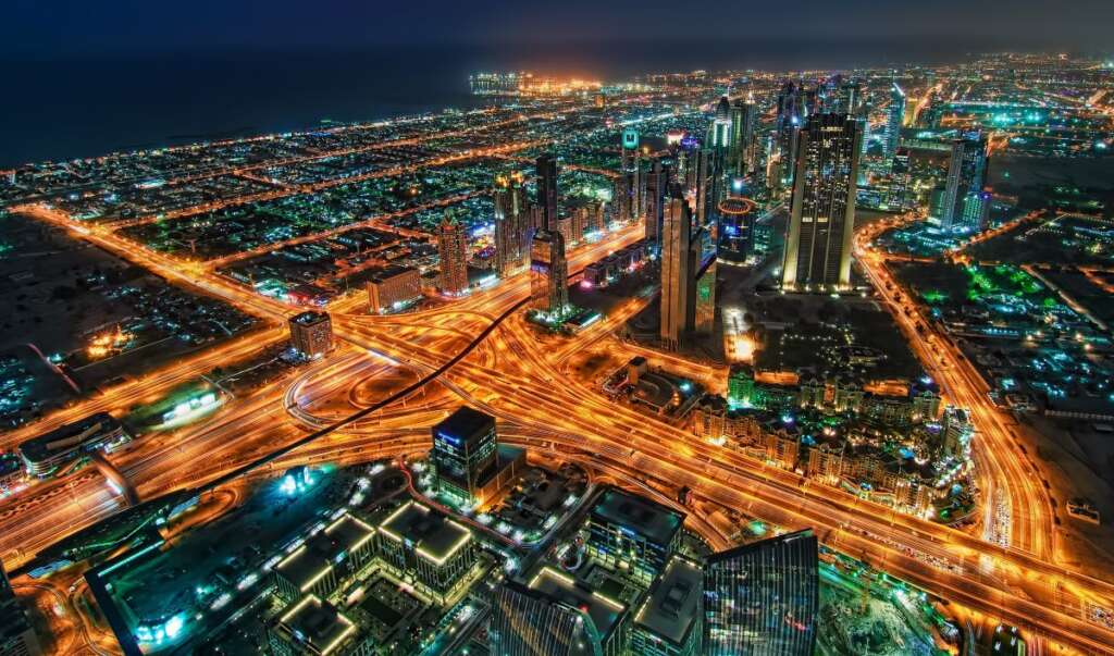 bus rental services in Dubai with a night skyscrapers at the sheikh zayed road in dubai